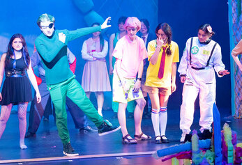 Students perform a lively ensemble scene in Portola High School’s “SpongeBob,” featuring colorful costumes and underwater-themed lighting.